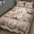 Close bedroom view of a Maltese dog quilt blanket with roses, bows, baskets, and ornate pink details