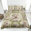 Maltese dog quilt blanket displayed on a bed with daisy artwork and green cottage-style accents