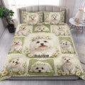 Maltese dog quilt blanket styled in a bright bedroom with floral dog artwork