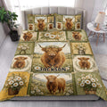 Highland cow quilt blanket styled on a bed with rustic floral farmhouse artwork
