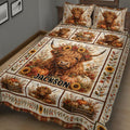 Rustic Highland Cow quilt blanket displayed on a bed with autumn flowers, pumpkins, and farmhouse decor