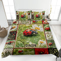 Ladybug quilt blanket displayed on a bed with daisies, green leaves, and botanical panels