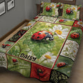 Close view of ladybug quilt blanket with daisies, leaves, red flowers, and garden-inspired panels
