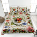 Ladybug quilt blanket bedding set displayed on a bed with flowers, leaves, and red gingham borders