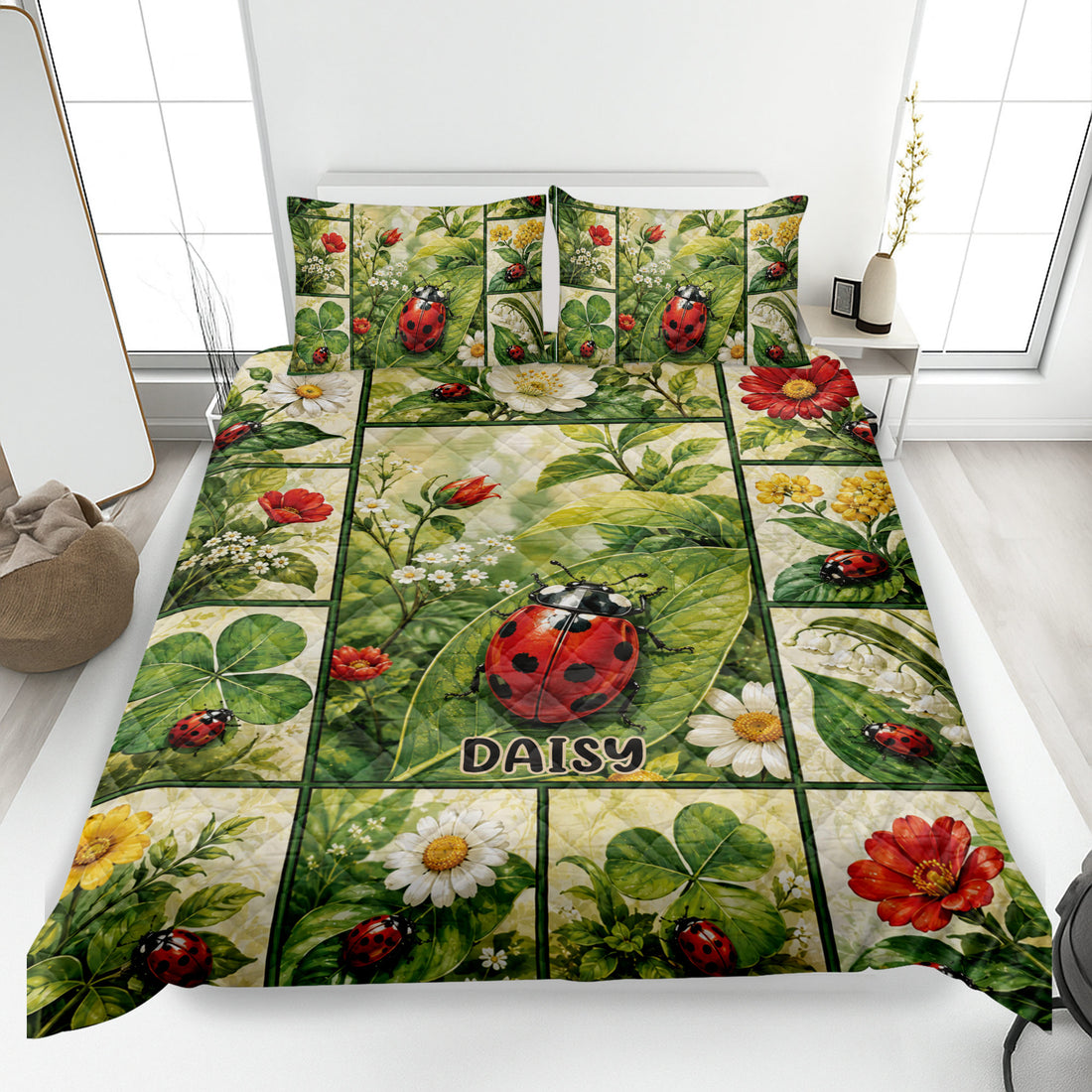 Ladybug quilt blanket displayed on a bed with floral greenery, red flowers, and leafy botanical artwork