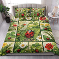 Ladybug quilt blanket styled in a bright bedroom with botanical flowers, leaves, and red ladybugs