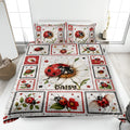Ladybug quilt blanket displayed on a bed with daisy flowers, red accents, and framed insect artwork