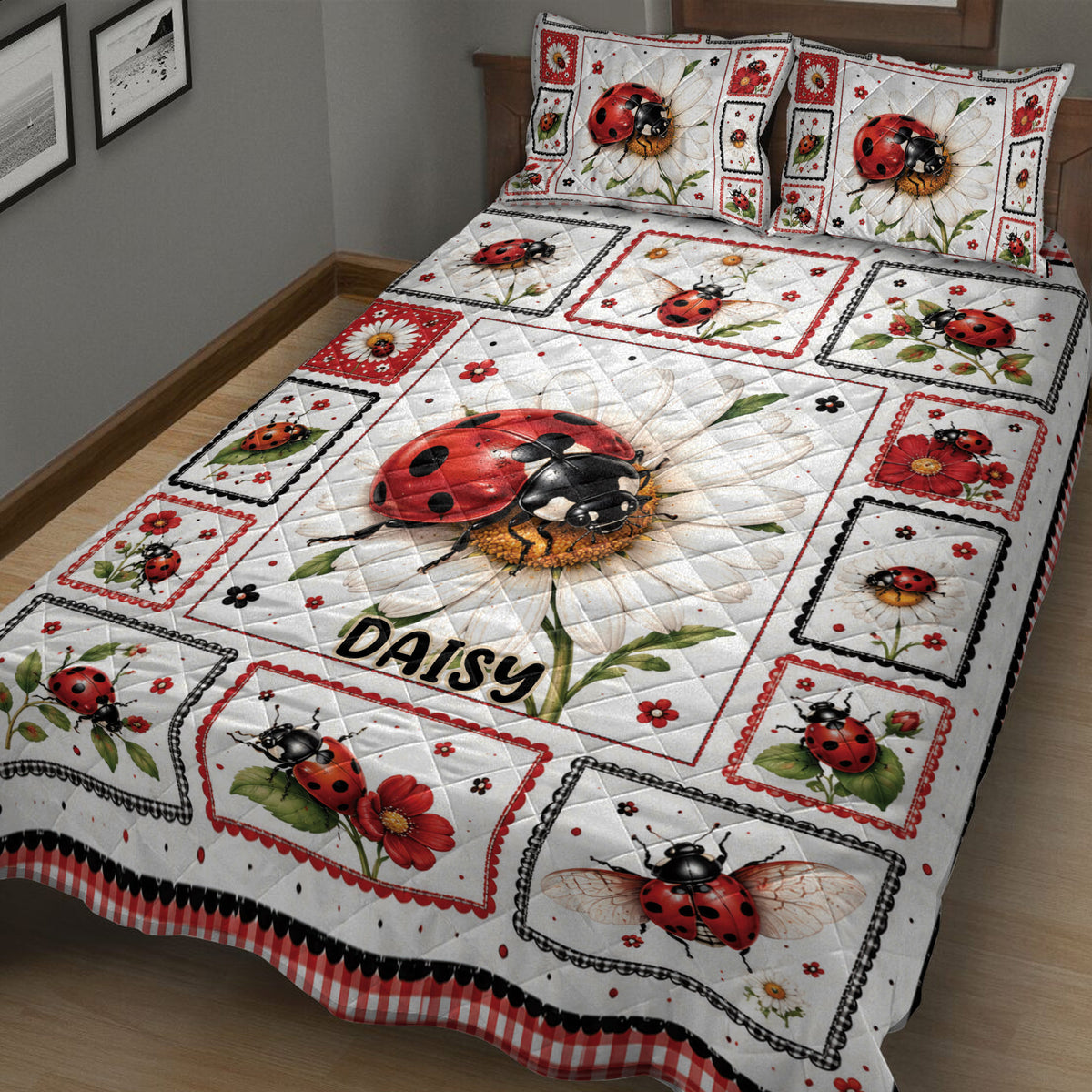 Close bedroom view of a red and black ladybug quilt with daisies, flowers, and framed panels