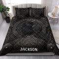 Viking raven quilt blanket styled in a bright bedroom with dark Norse artwork and ornamental shield details