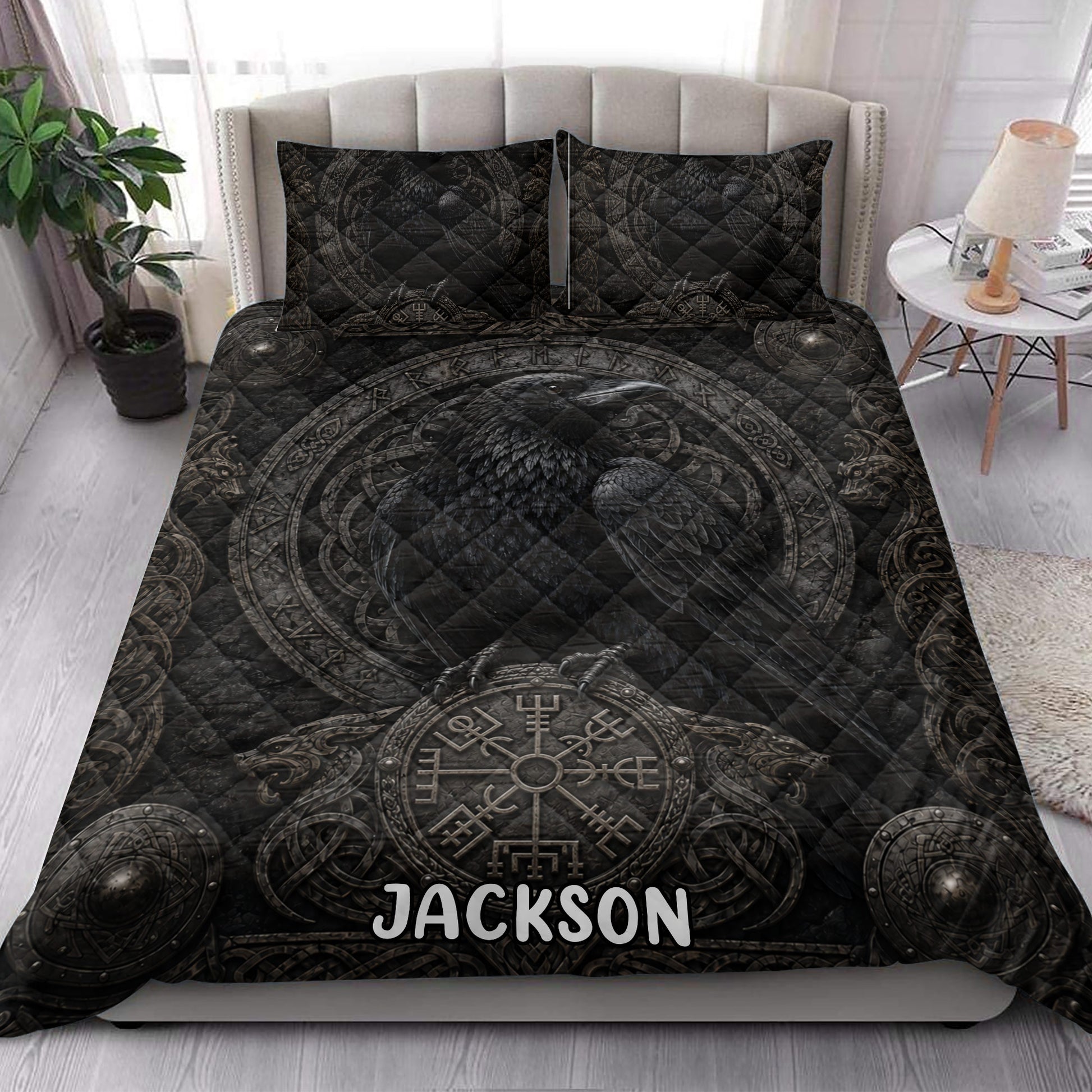 Viking raven quilt blanket styled in a bright bedroom with dark Norse artwork and ornamental shield details