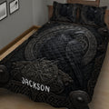 Close bedroom view of a Viking quilt blanket featuring a large black raven, runic symbols and Nordic knotwork