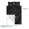 Viking quilt blanket close-up showing the printed Norse design, white quilted backing, and decorative knotwork