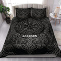 Black Viking quilt bedding set styled in a bright bedroom with Norse symbols, dragons, and intricate gray knotwork