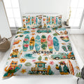 Surfing quilt blanket displayed on a bed with colorful surfboards, tropical beach scenes, waves, and island artwork