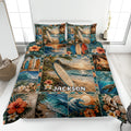 Surfing quilt blanket displayed on a bed with tropical beach scenes, surfboards, waves, hibiscus flowers, and sea turtles