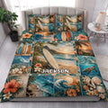 Tropical surfing quilt blanket styled on a bed with surfboards, ocean waves, palm trees, and colorful beach artwork