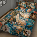 Close view of a surfing quilt blanket with ocean waves, surfboards, hibiscus flowers, palm trees, and seashells