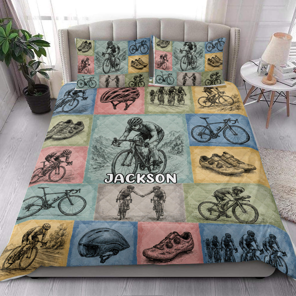 Custom bicycle quilt blanket styled on a bright bedroom bed with cyclists, bicycles, helmets, and shoes