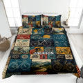 Bicycle quilt blanket displayed on a bed with vintage cycling, mountain, road, and bicycle collage artwork