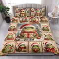 Festive frog quilt blanket styled in a bright bedroom with Santa hats, gifts, and Christmas greenery