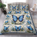 Blue butterfly floral quilt blanket displayed in an elegant bedroom setting