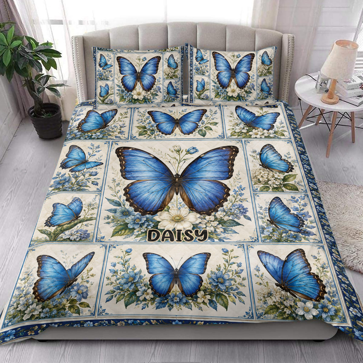Blue butterfly floral quilt blanket displayed in an elegant bedroom setting