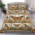Butterfly quilt blanket styled in a bright bedroom with orange butterflies and garden flowers