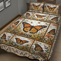 Close bedroom view of a floral butterfly quilt with repeated orange monarch butterfly artwork