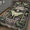 Dark botanical butterfly quilt blanket displayed across a bed with coordinating butterfly artwork
