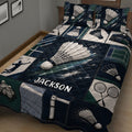 Badminton bedding quilt shown across a bed with bold navy artwork, shuttlecocks, rackets, and player silhouettes