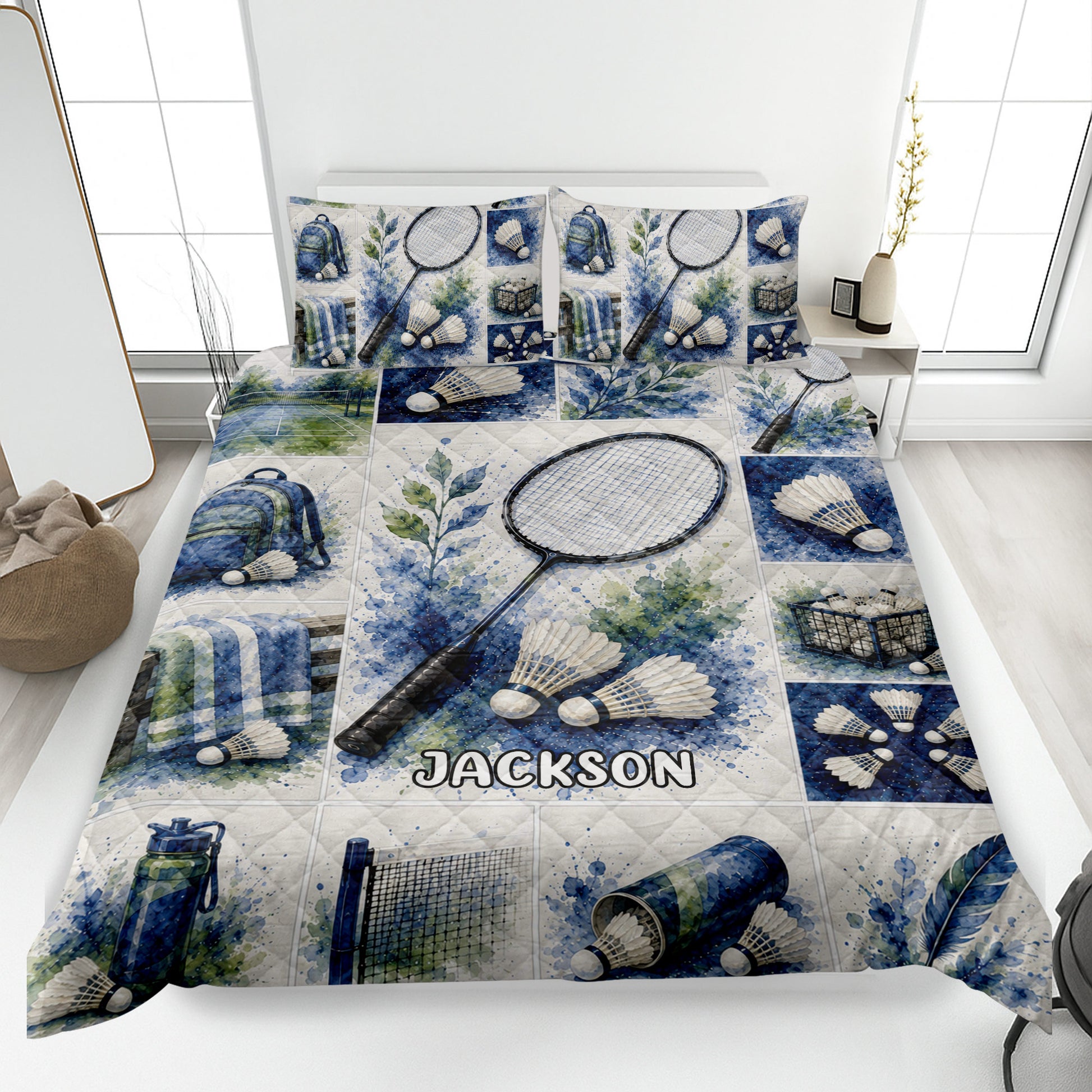 Badminton quilt blanket displayed on a bed with rackets, shuttlecocks, backpacks, and blue watercolor sports artwork