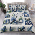 Badminton quilt blanket styled on a bed with matching badminton artwork in blue, green, and white tones
