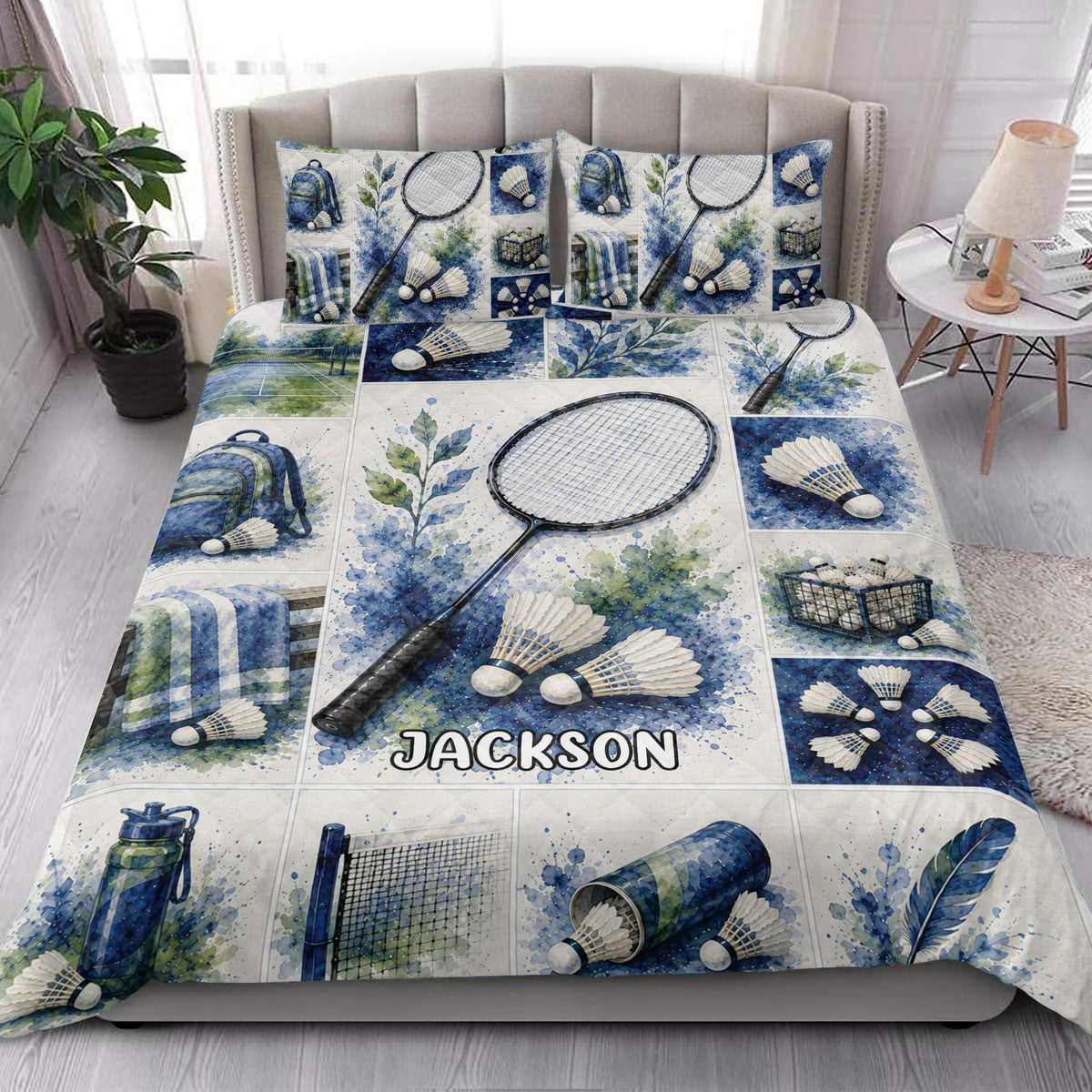 Badminton quilt blanket styled on a bed with matching badminton artwork in blue, green, and white tones