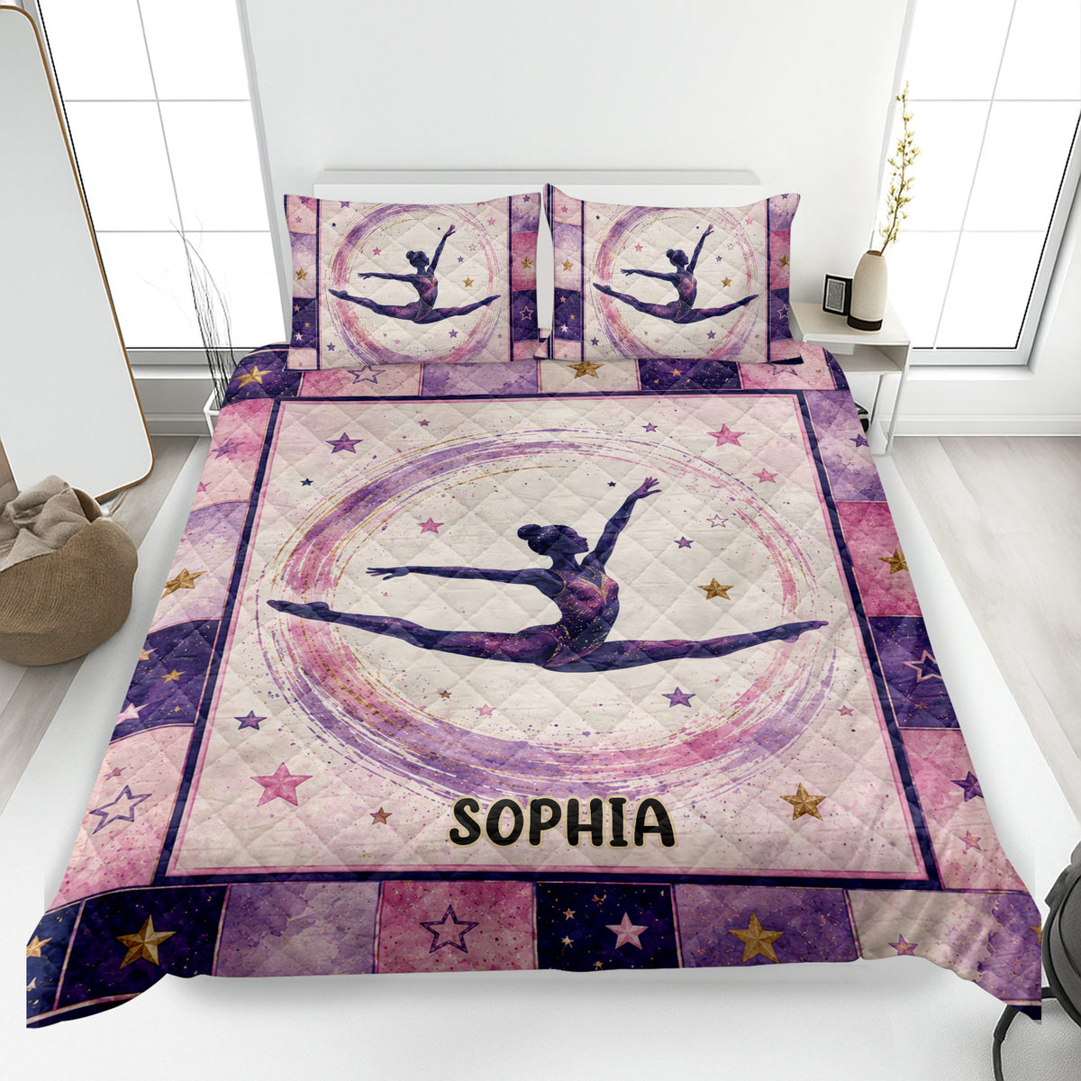 Gymnastics quilt blanket displayed on a bed with a female gymnast, stars, and pink and purple artwork