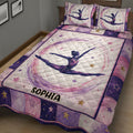 Close view of a gymnastics quilt blanket featuring a female gymnast surrounded by colorful stars