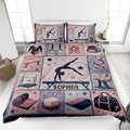 Gymnastics quilt blanket displayed on a bed with gymnast artwork, stars and gymnastics apparatus