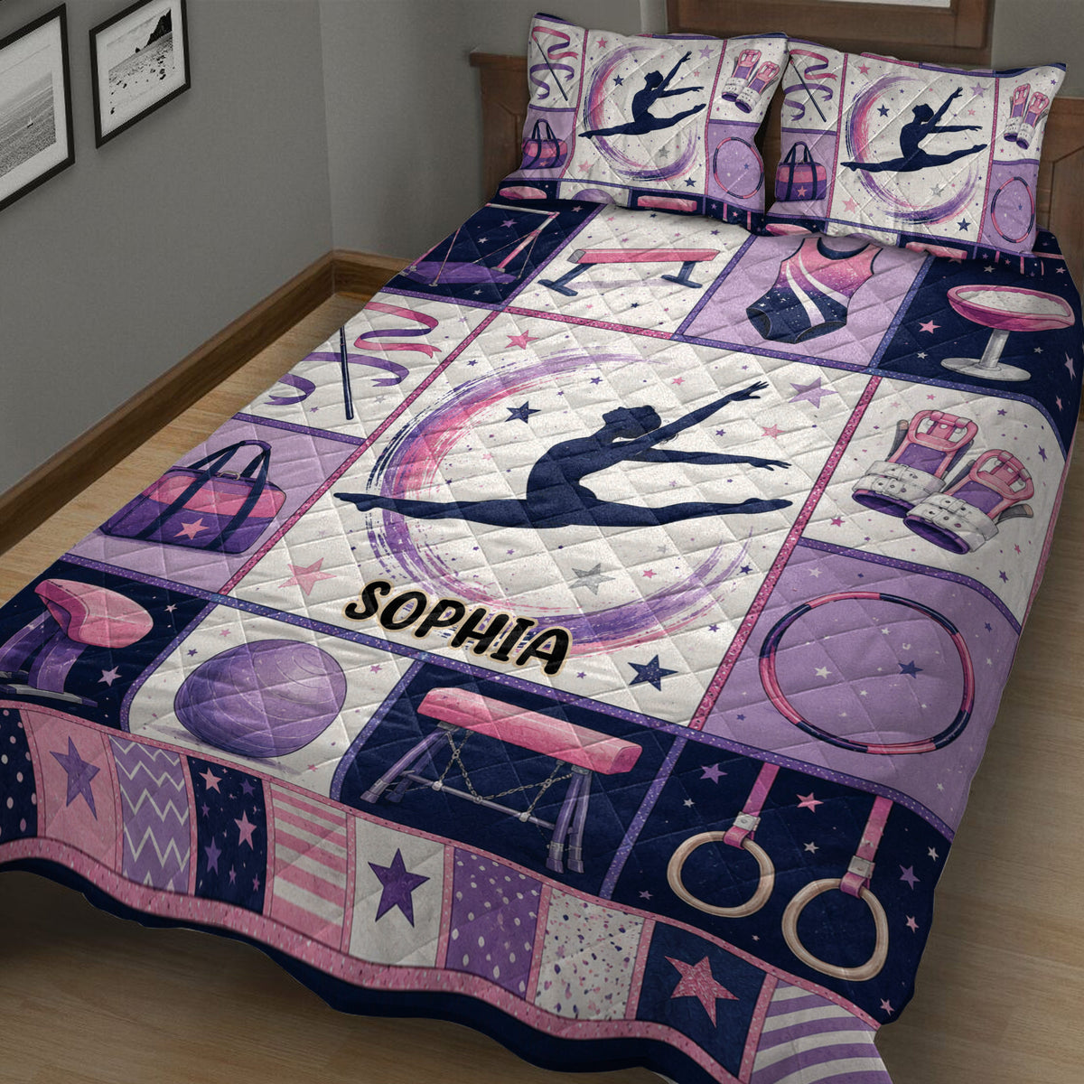Close bedroom view of a gymnastics quilt with gymnast silhouette, rings, bars, ribbon, and stars