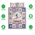 Gymnastics quilt bedding set shown flat with floral panels, gymnast artwork, and care feature icons