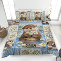 Otter quilt blanket displayed on a bed with daisy artwork, blue water scenery, and playful otter portraits