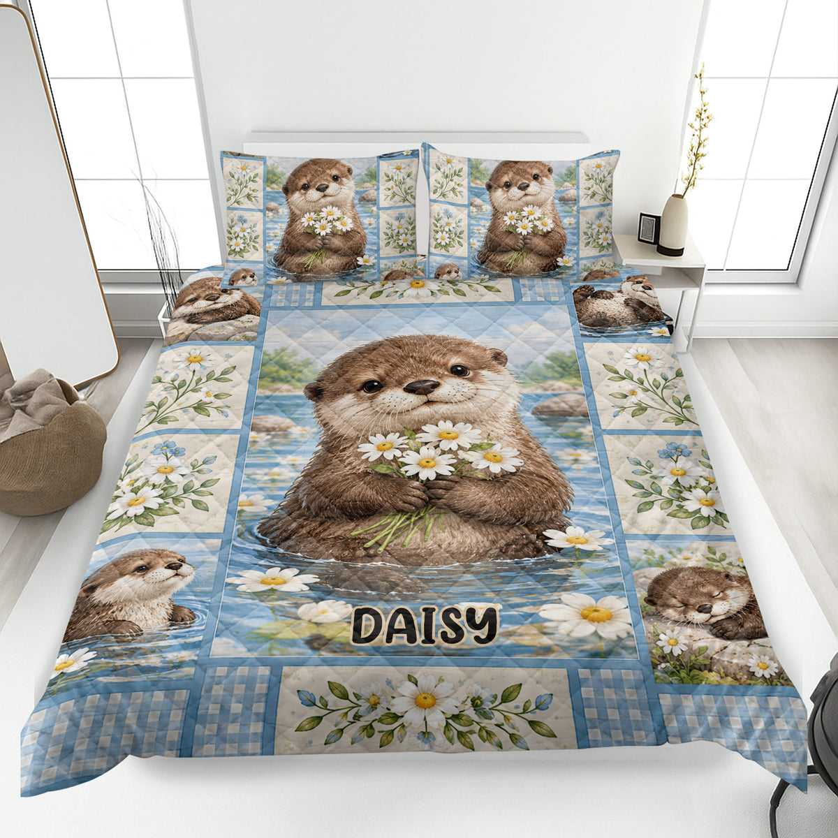 Otter quilt blanket displayed on a bed with daisy artwork, blue water scenery, and playful otter portraits