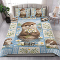 Otter quilt bedding styled in a bright bedroom with blue water, daisy, and woodland artwork