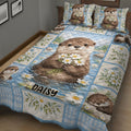 Close view of otter quilt blanket with floral stream artwork and multiple cheerful otter portraits