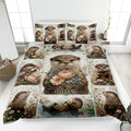 Otter quilt blanket displayed on a bed with floral artwork, water scenes, and a large central otter portrait