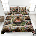 Otter quilt blanket displayed on a bed with lotus flowers, pond scenery, and colorful wildlife artwork