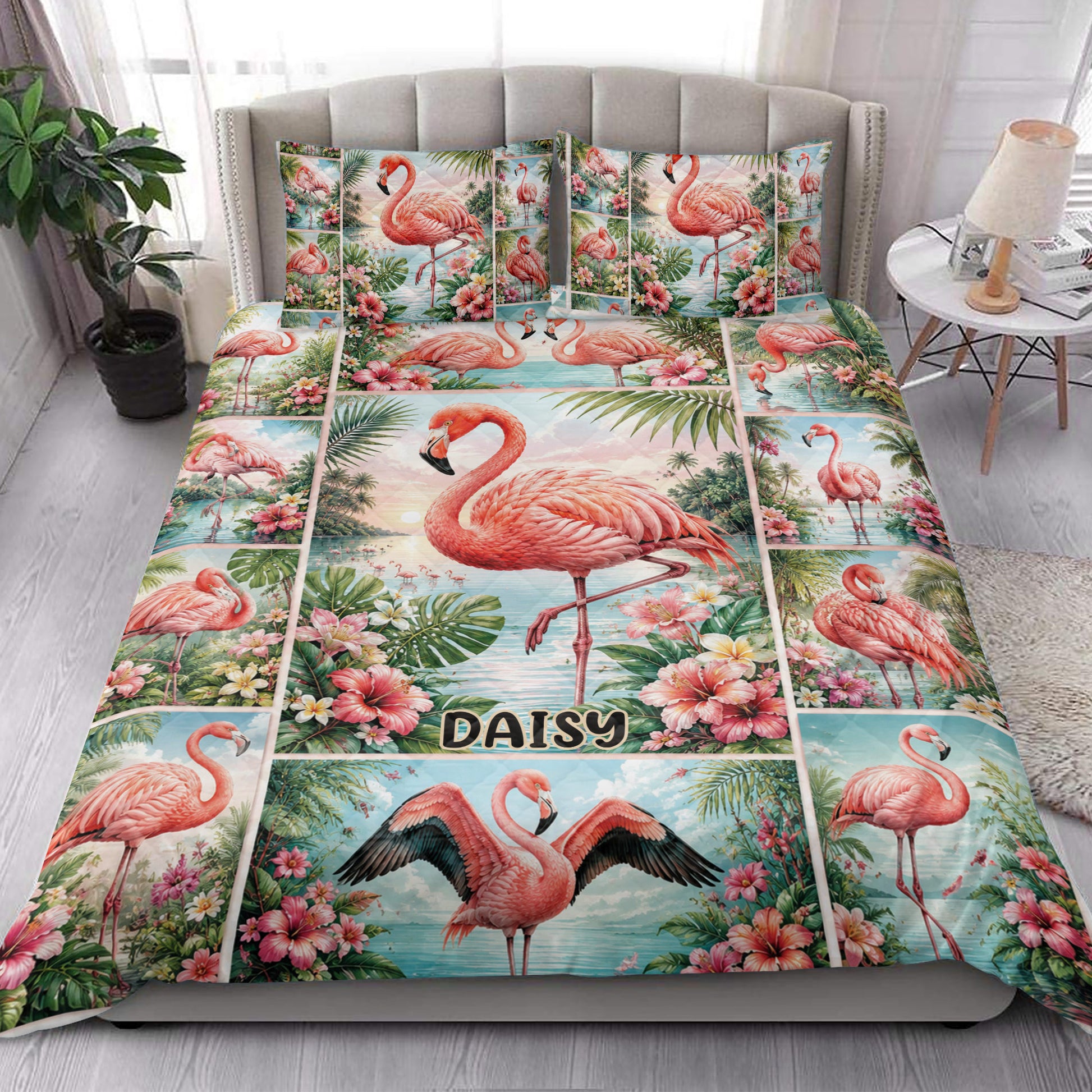 Tropical flamingo quilt blanket styled on a bed with pink hibiscus flowers and lush palm leaves