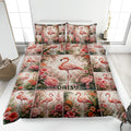 Flamingo quilt blanket bedding set displayed on a bed with pink flowers and tropical botanical artwork