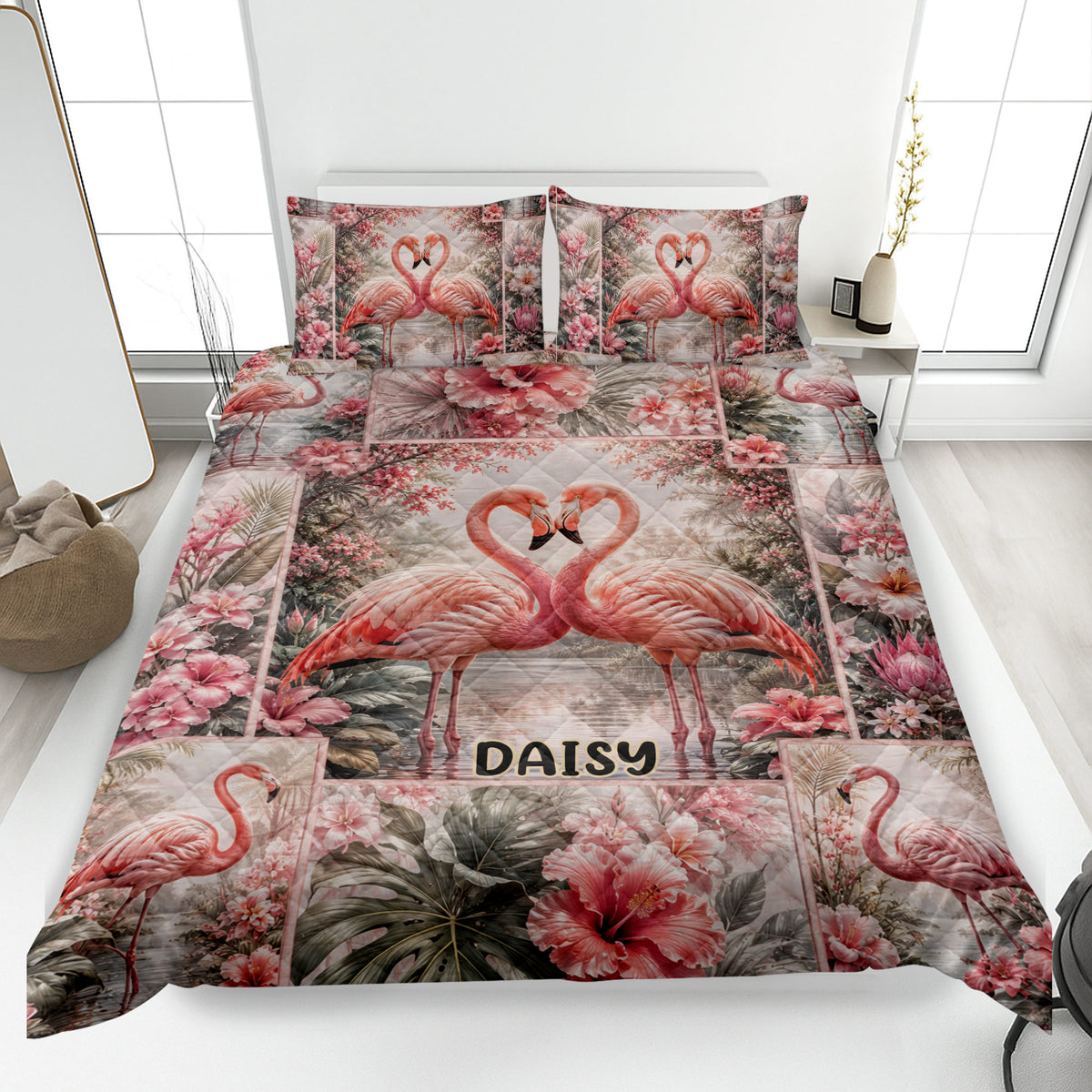 Flamingo quilt blanket displayed on a bed with tropical flowers and paired flamingos forming heart shapes