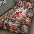 Close bedroom view of a Christmas flamingo quilt blanket with ornaments, gifts, trees, and poinsettias