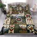 Archery quilt blanket styled on a bedroom bed with colorful target and mountain artwork