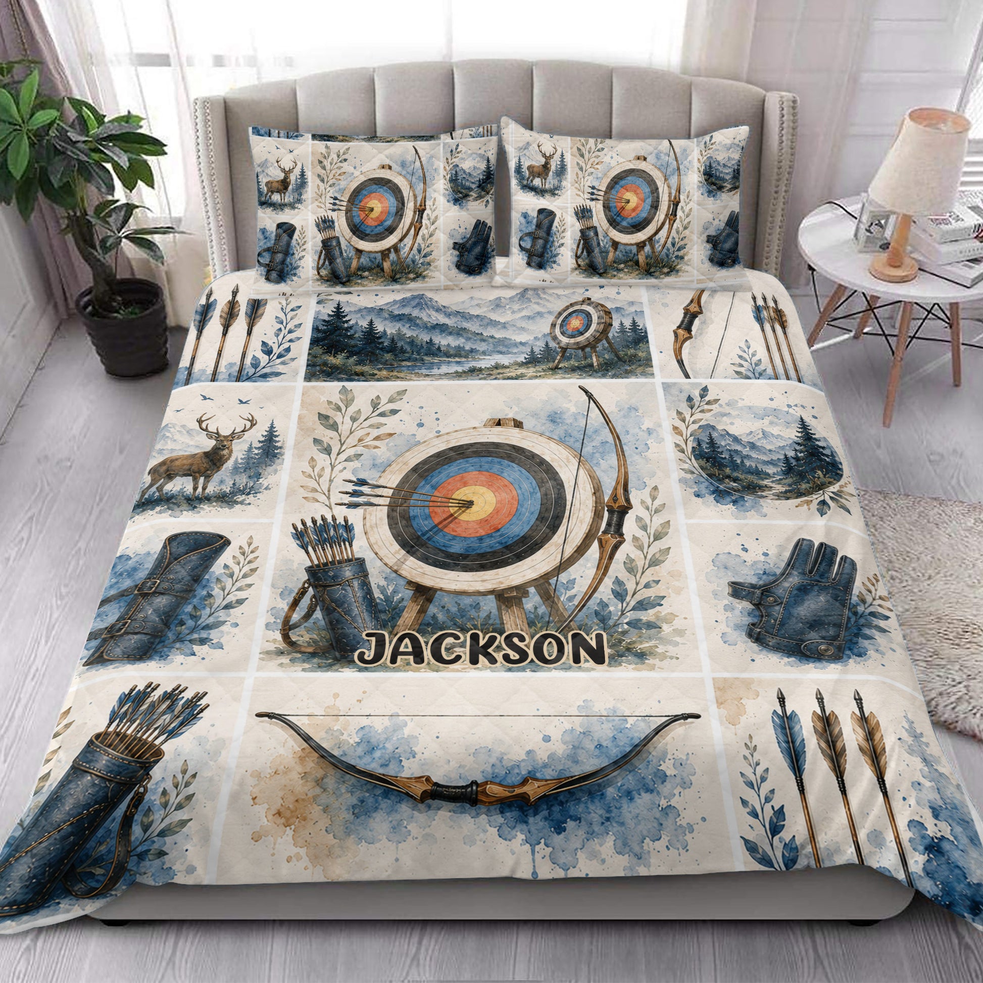Archery quilt blanket styled in a bedroom with target, bow, arrow, quiver, deer, and mountain artwork